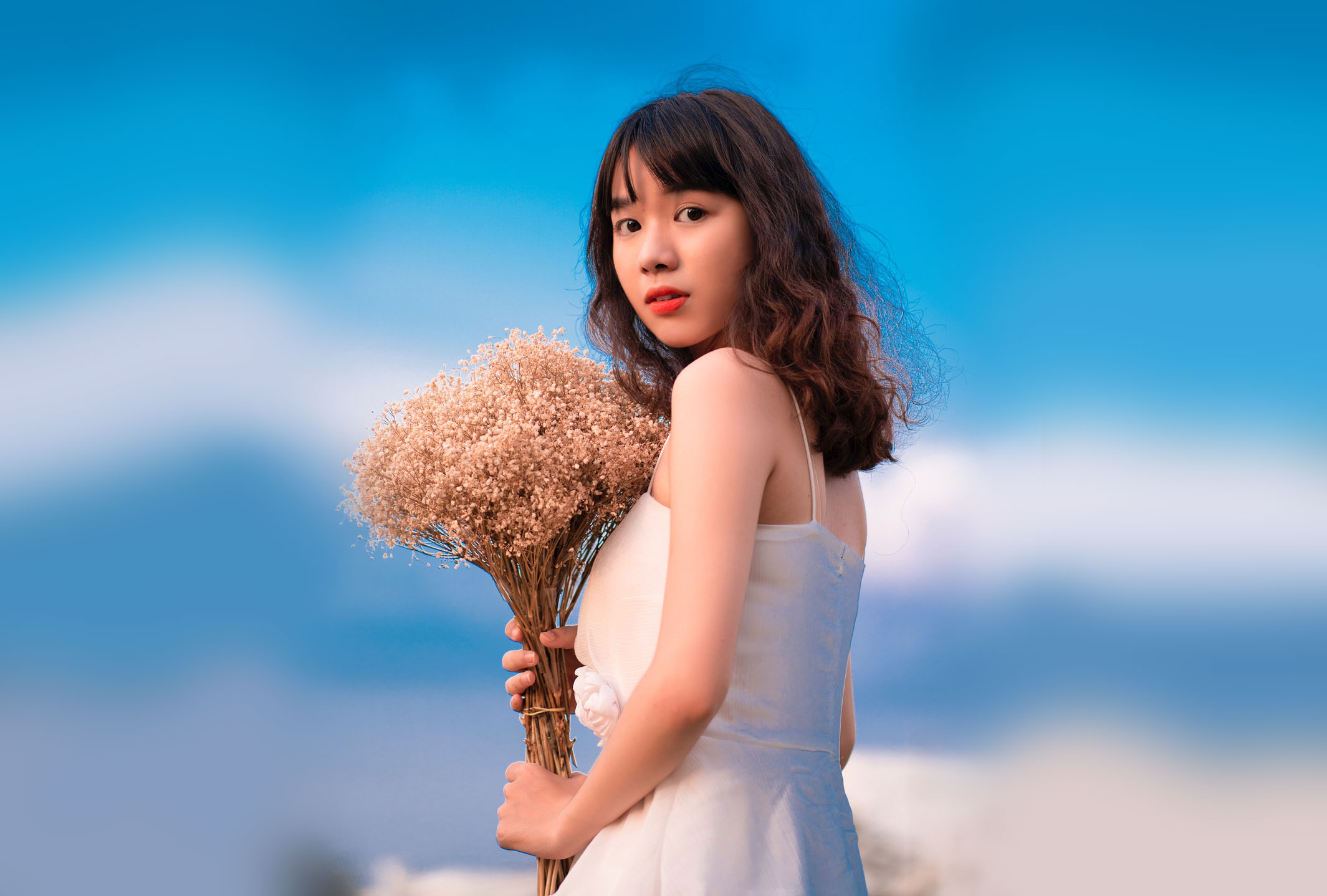 asian woman holding flowers